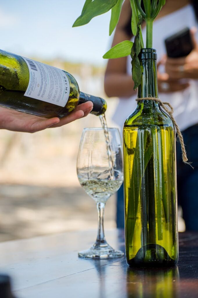 A person pouring wine into a wine bottle